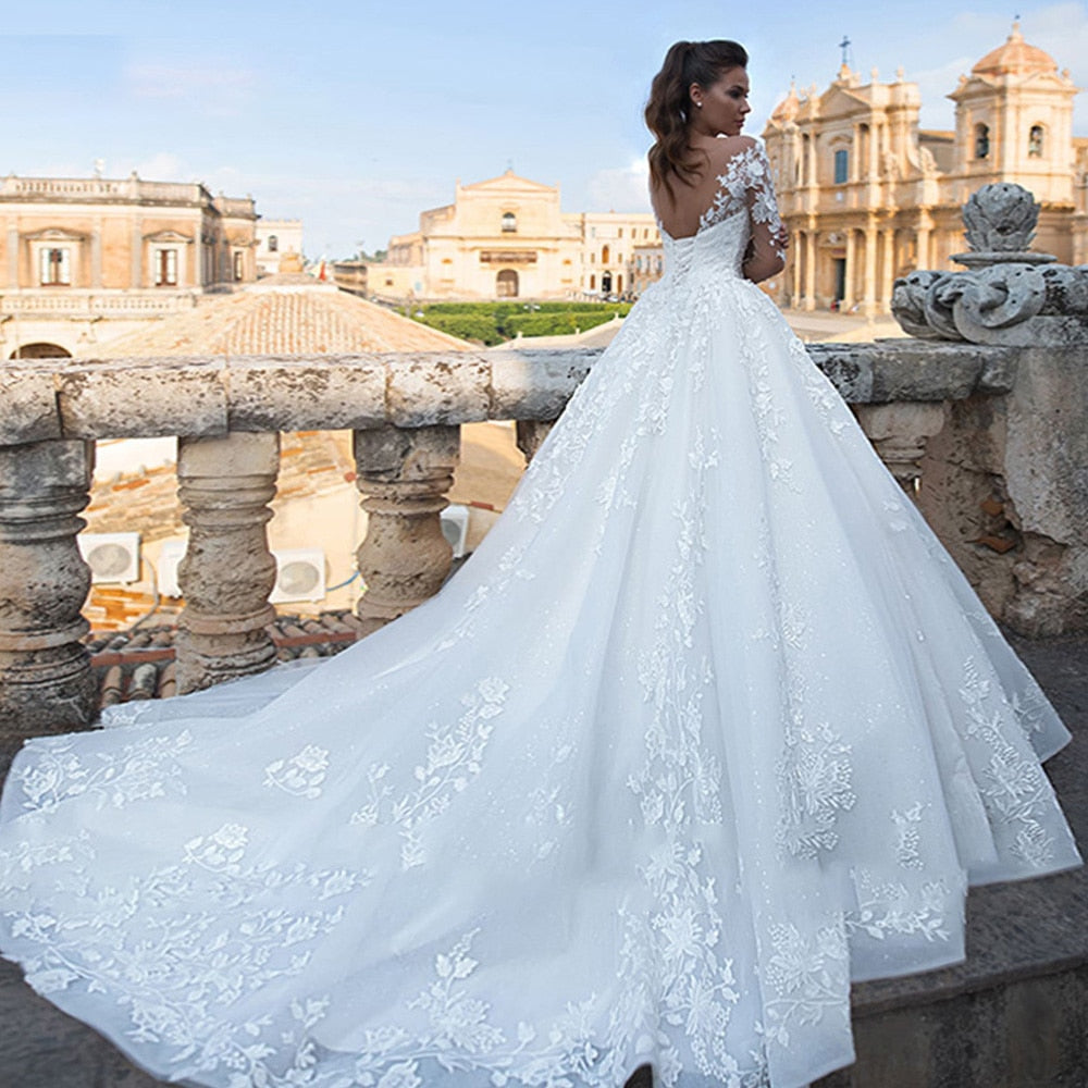 Backless Long Sleeve Ball Gown Wedding Dress with Pearls and Appliques